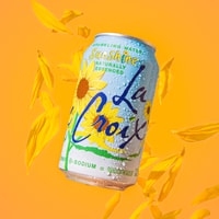 Retro “Live LaCroix” pop‑up stand with bright signage and fruit graphics at an outdoor event.